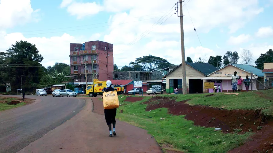 Person carrying chewing gum in a bag to sell in Kenya