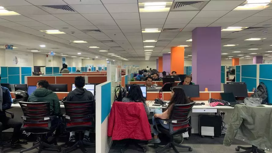 People working at computers in a shared computer space in India