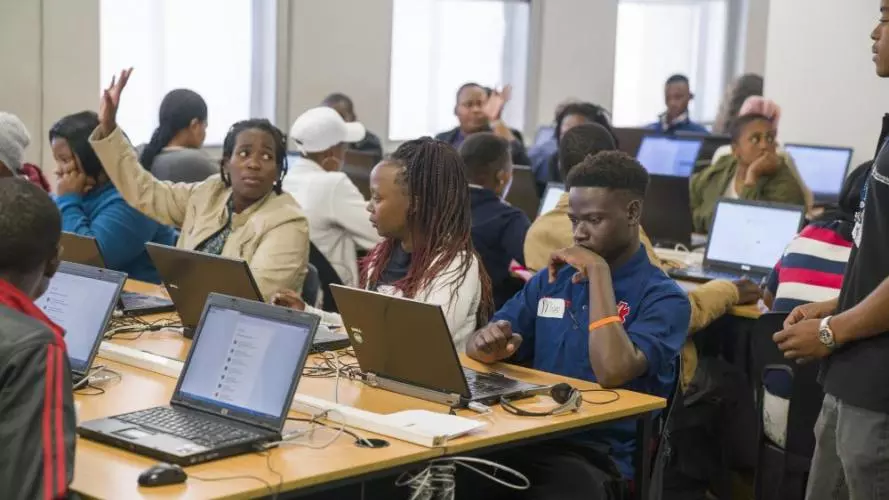 People sitting at computers on a training course by Harambee in South Africa