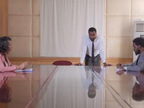 Three people in an office room