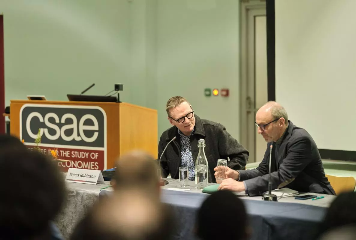 James Robinson and Stefan Dercon sit at the panel table at CSAE Conference 2025