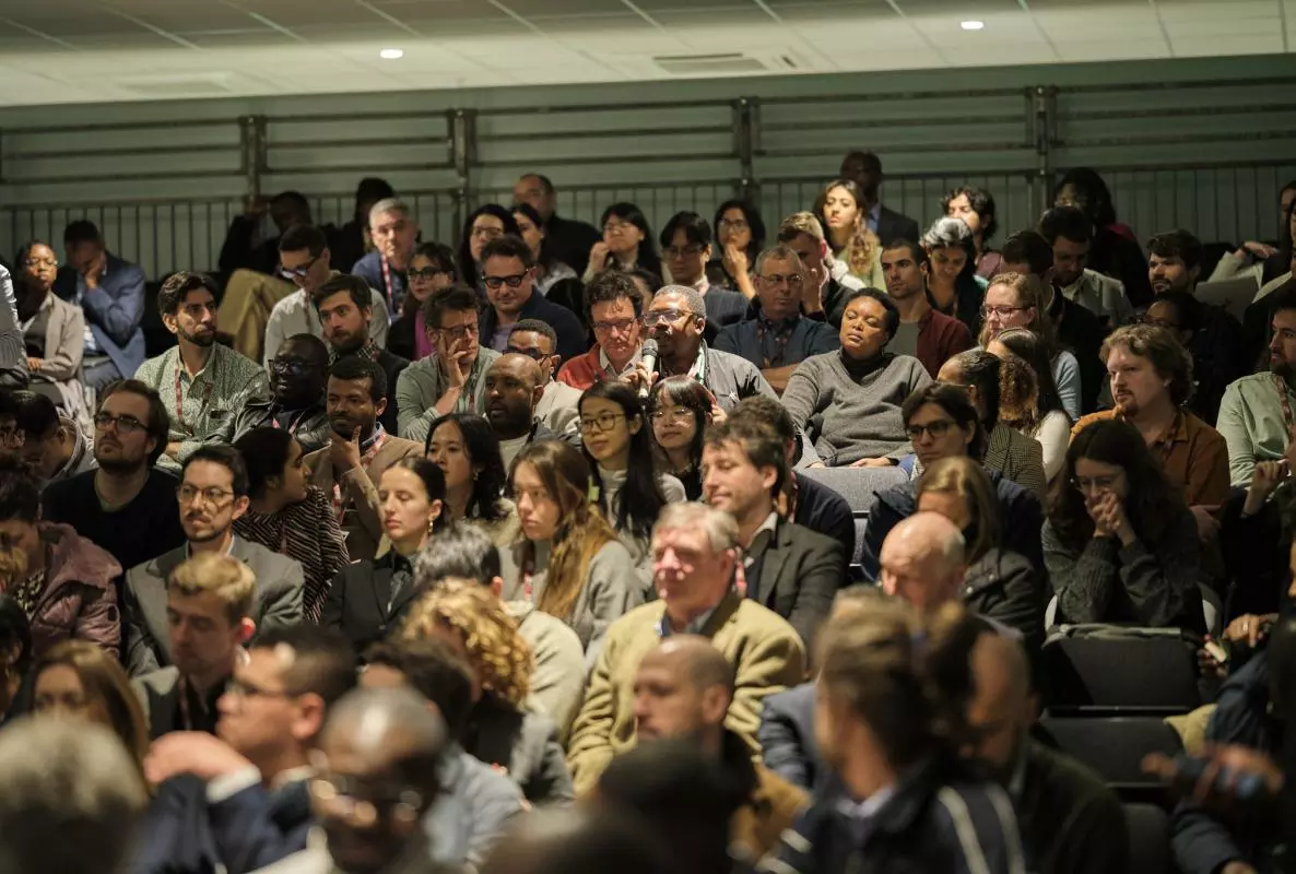 A question is asked in a full lecture theatre at the CSAE Conference