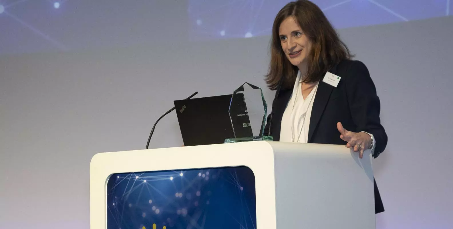Photograph of Kate Orkin accepting the ESRC Outstanding Public Policy Impact Prize in November 2023