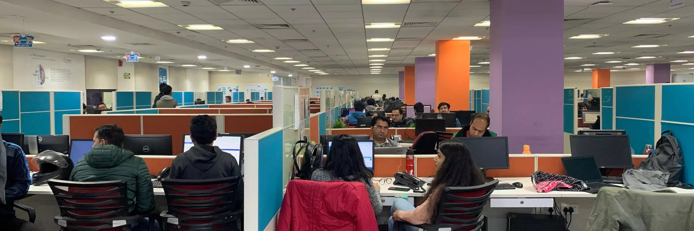 People working at computers in a shared computer space in India