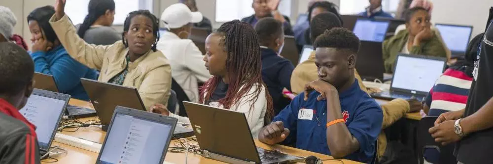 People sitting at computers on a training course by Harambee in South Africa