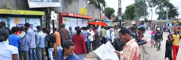 Lots of people look at job listings on the street in Addis Ababa