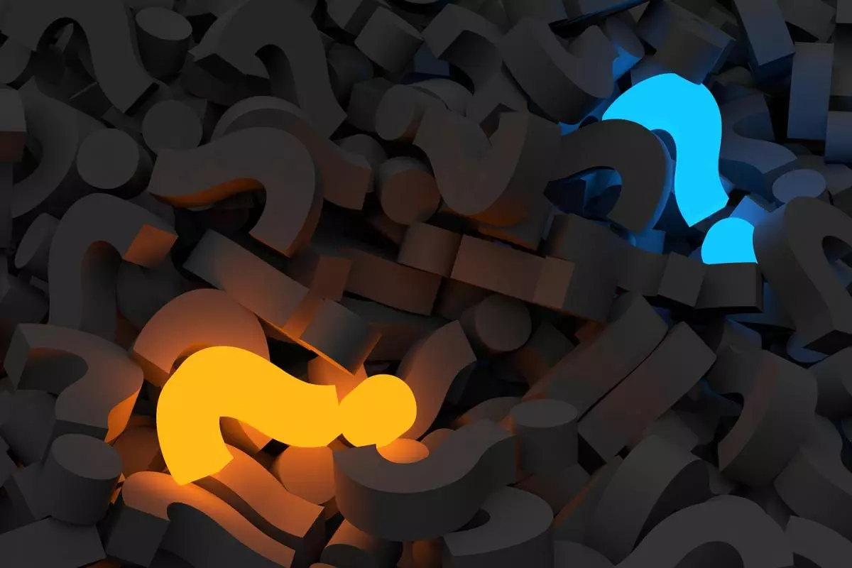 Question marks lit up with a dark background